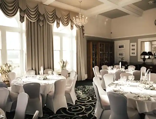Dining tables in a room prepared for a wedding celebration