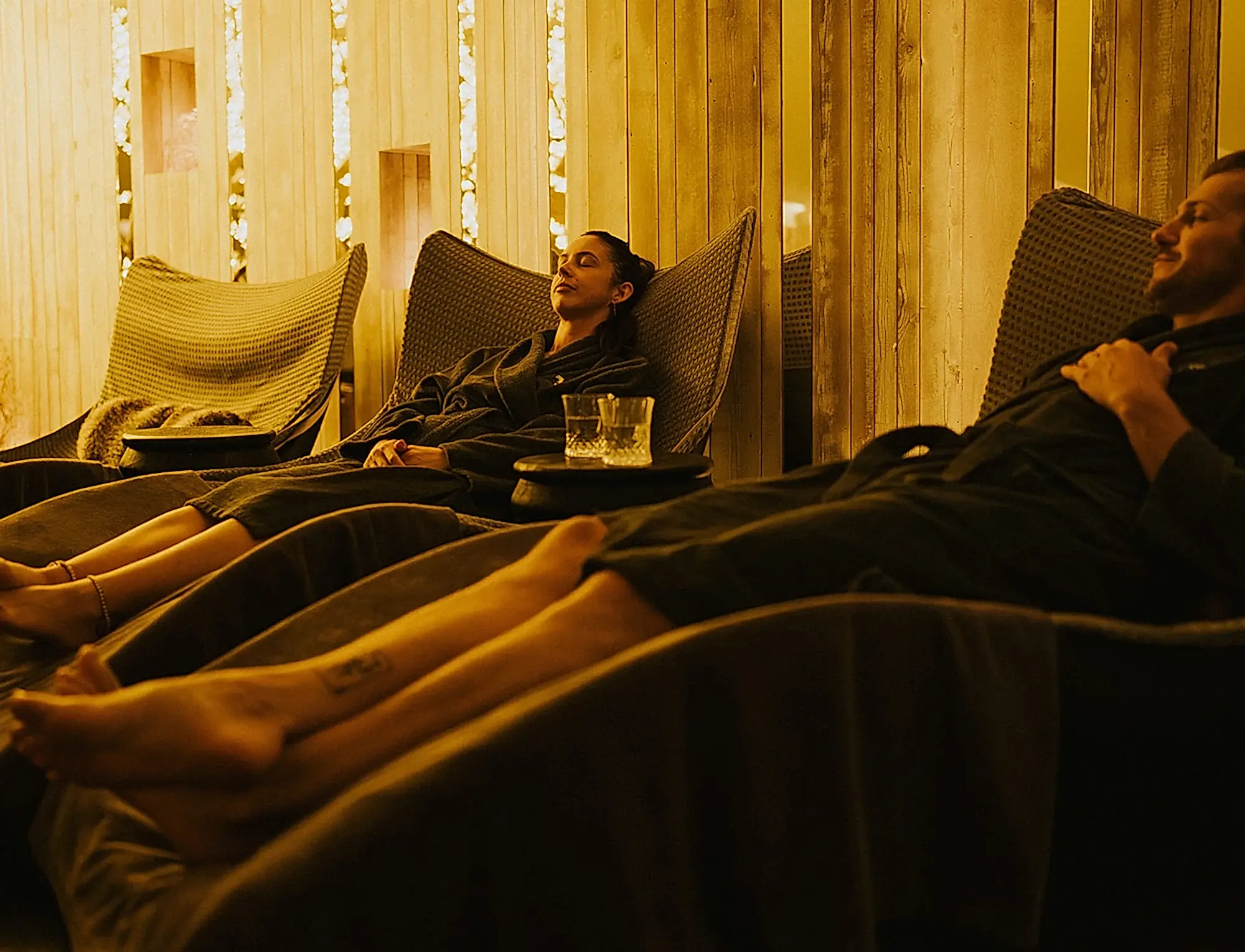 Two men relaxing in a dimly lit spa