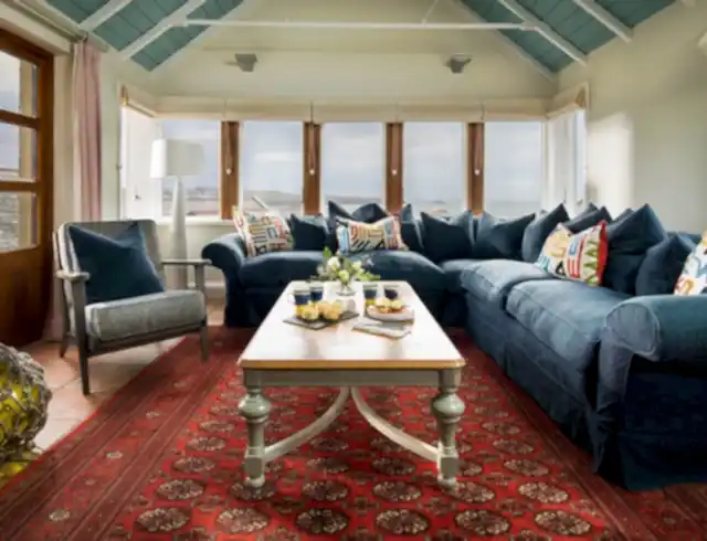 a living area in a conservatory overlooking the beach