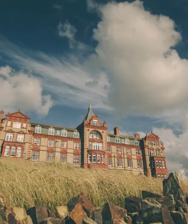  a view of the headland hotel from the grass outside