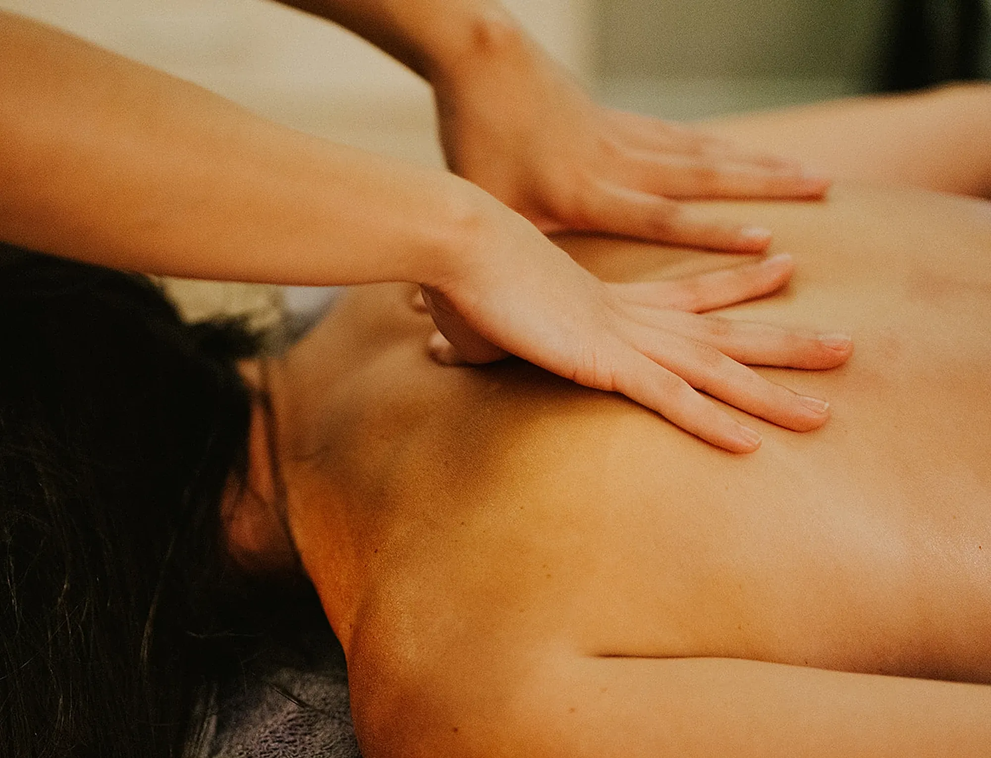 Hands massaging a female upper body