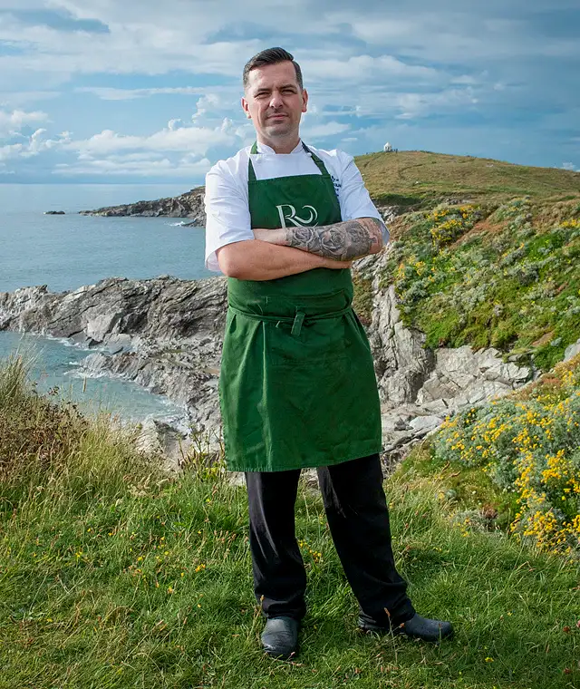 A chef proudly standing on the hill at the Headland Hotel