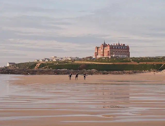 istral Beach image with The Headland Hotel behind sat on the cliffs. 