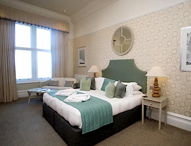 A large bed in an ocean view bedroom