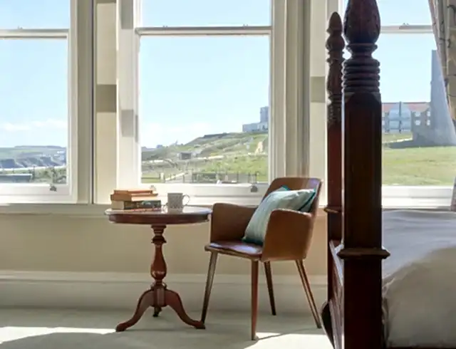 a table and chair overlooking a view of the cliffs outside