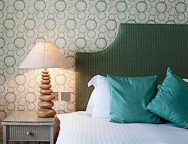 a bedside view of a room in a ocean view bedroom