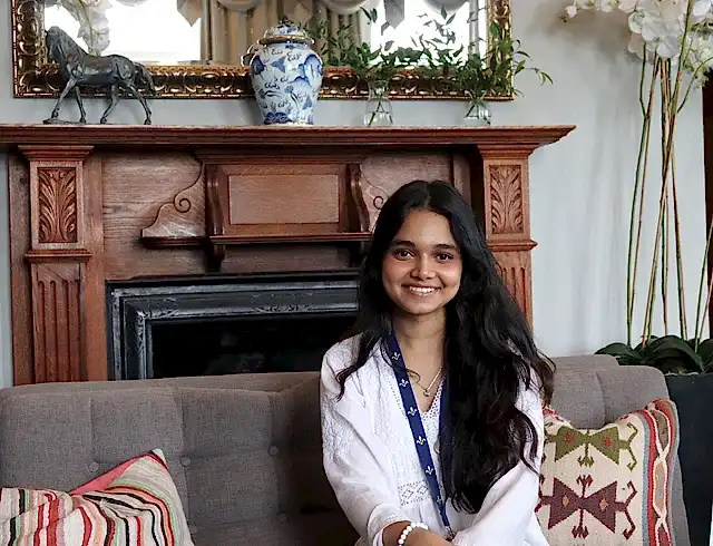 Anjali sitting on a sofa