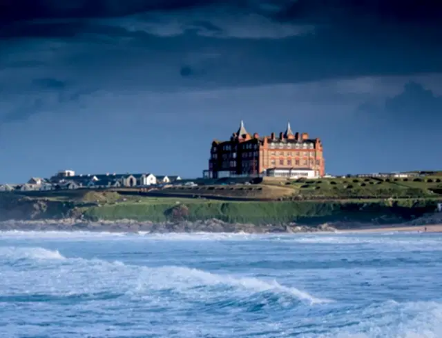Fistral Beach image with The Headland Hotel behind sat on the cliffs. 