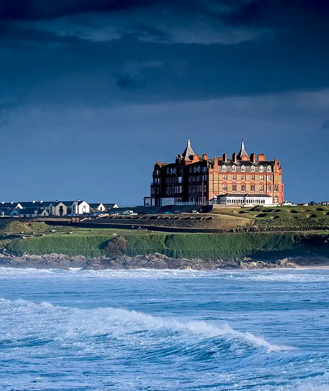Fistral Beach image with The Headland Hotel behind sat on the cliffs. 