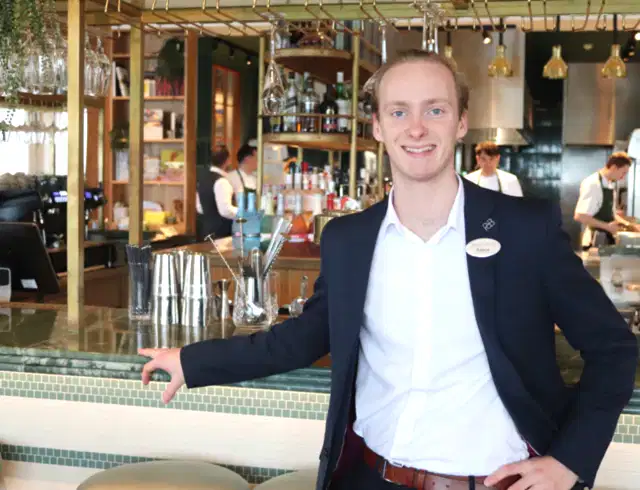 A man standing proudly at the bar
