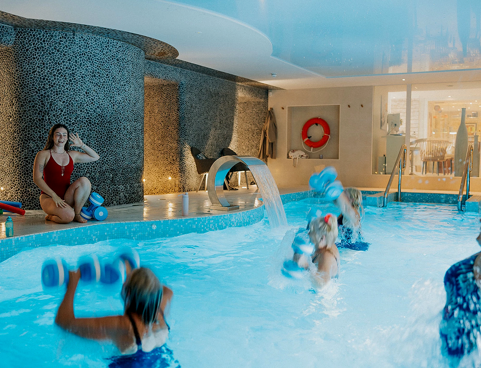 An aerobics class in a swimming pool