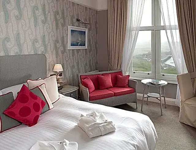 a luxury bedroom with a sofa and a large bed