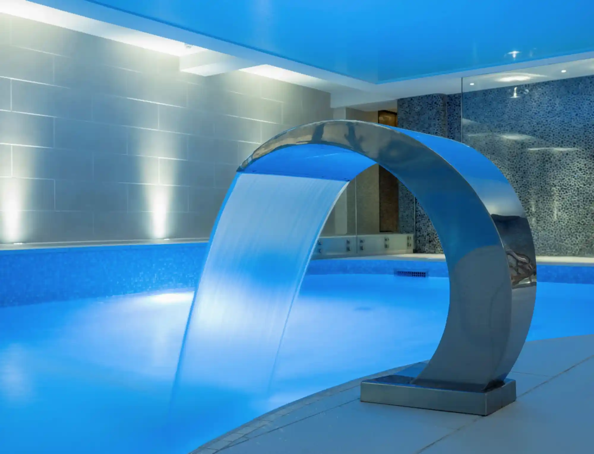 Water flowing into a swimming pool with flourescent light