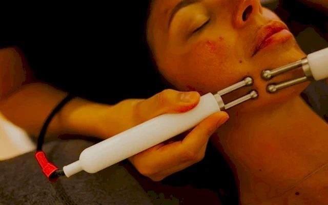 A woman receiving treatment aided by some machinery