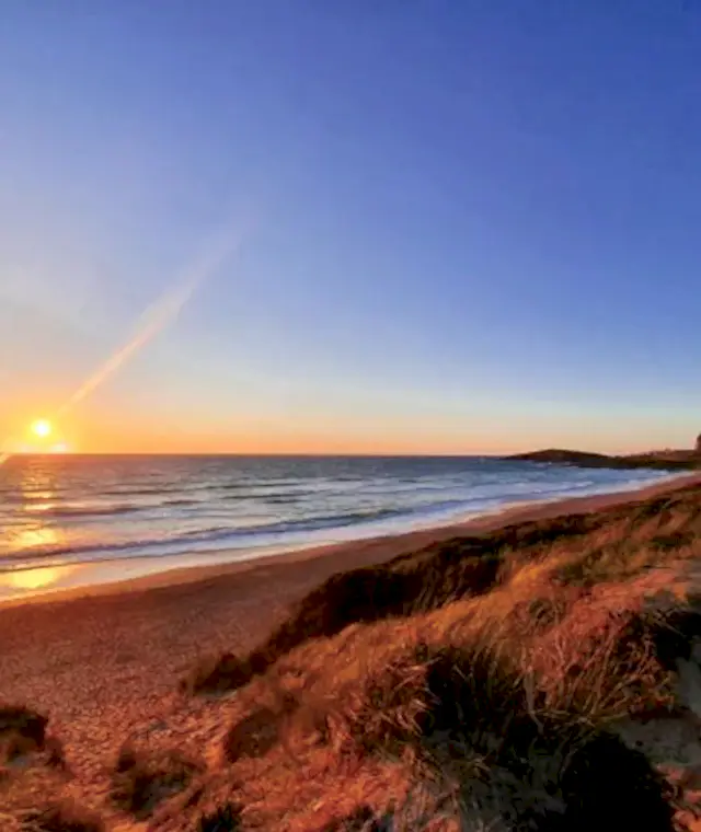 Sunset over the beach outside the Headland Hotel
