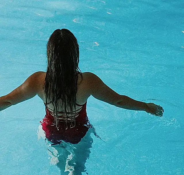 a woman in a swimming pool about to go swimming