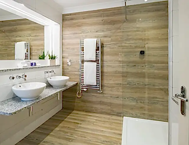 a luxury bathroom in a cosy room in the headland hotel