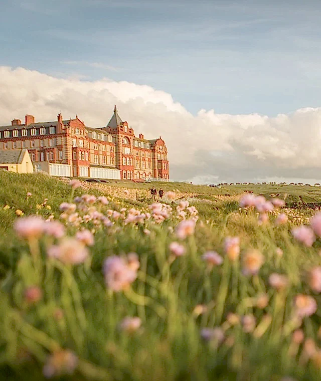 a grassy meadow outside the Headland Hotel