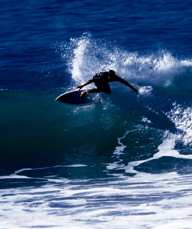 A man surfing on a wave on a summer's day