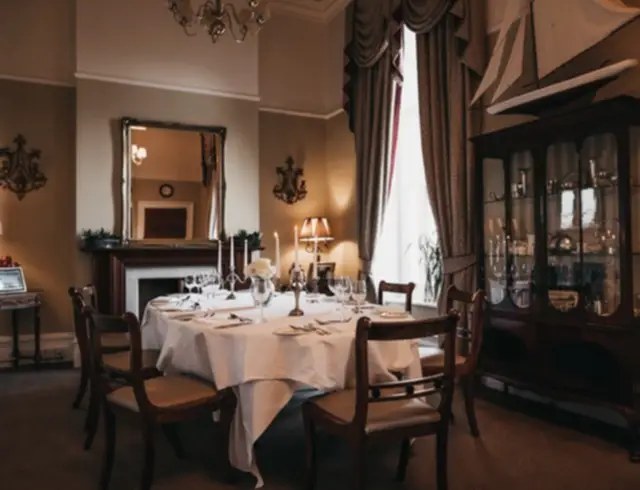 A dining table in a dining room with a full length window